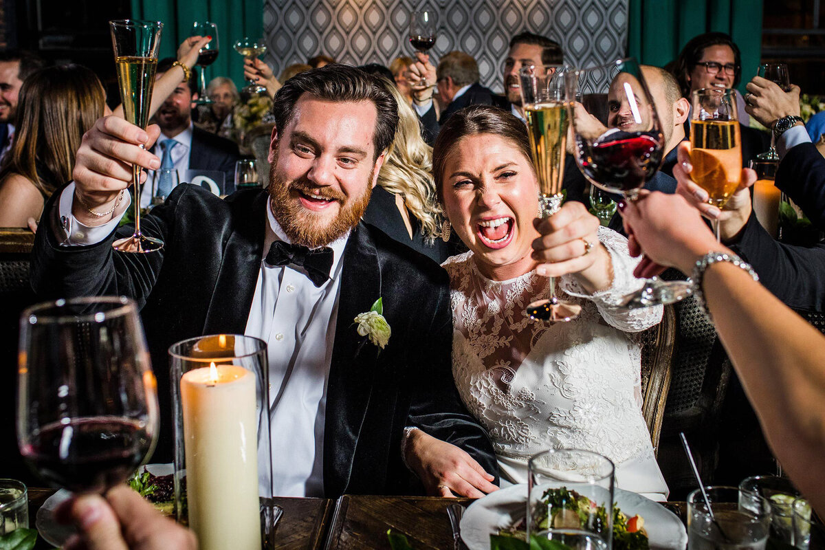 A couple toasts with guests at their Chicago wedding.