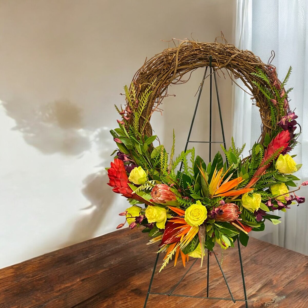 tropical funeral wreath flowers make  by Buds Blooms and Blossoms