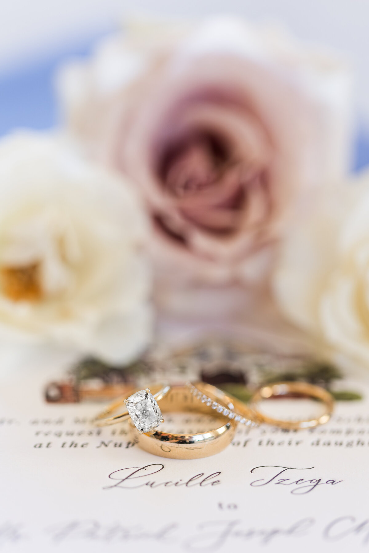 wedding rings on invitations with roses