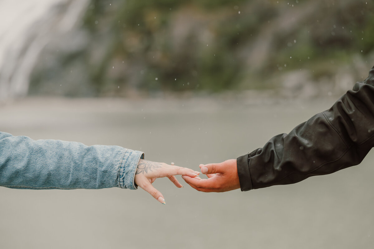 couple reach to each other and hold hands