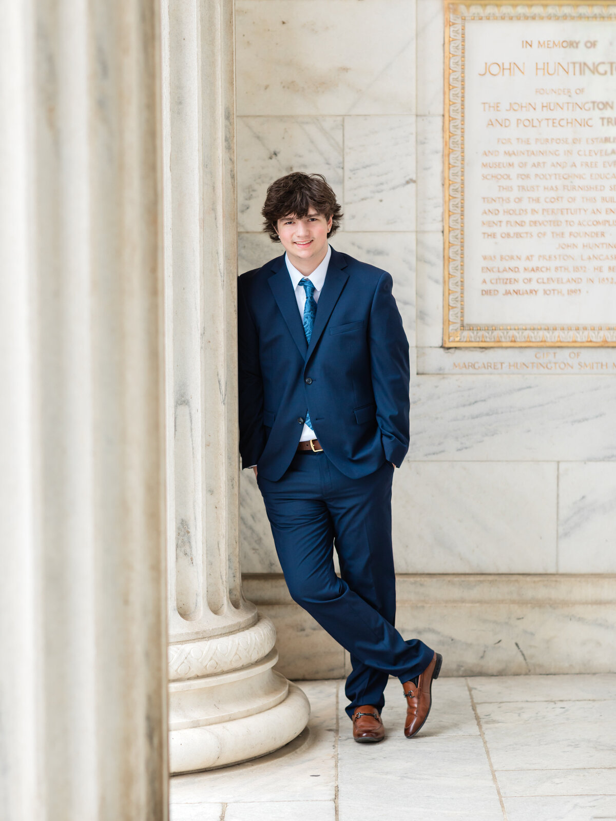 high school senior boy in blue suit posed at Cleveland Museum of Art for portraits Cleveland senior photographer
