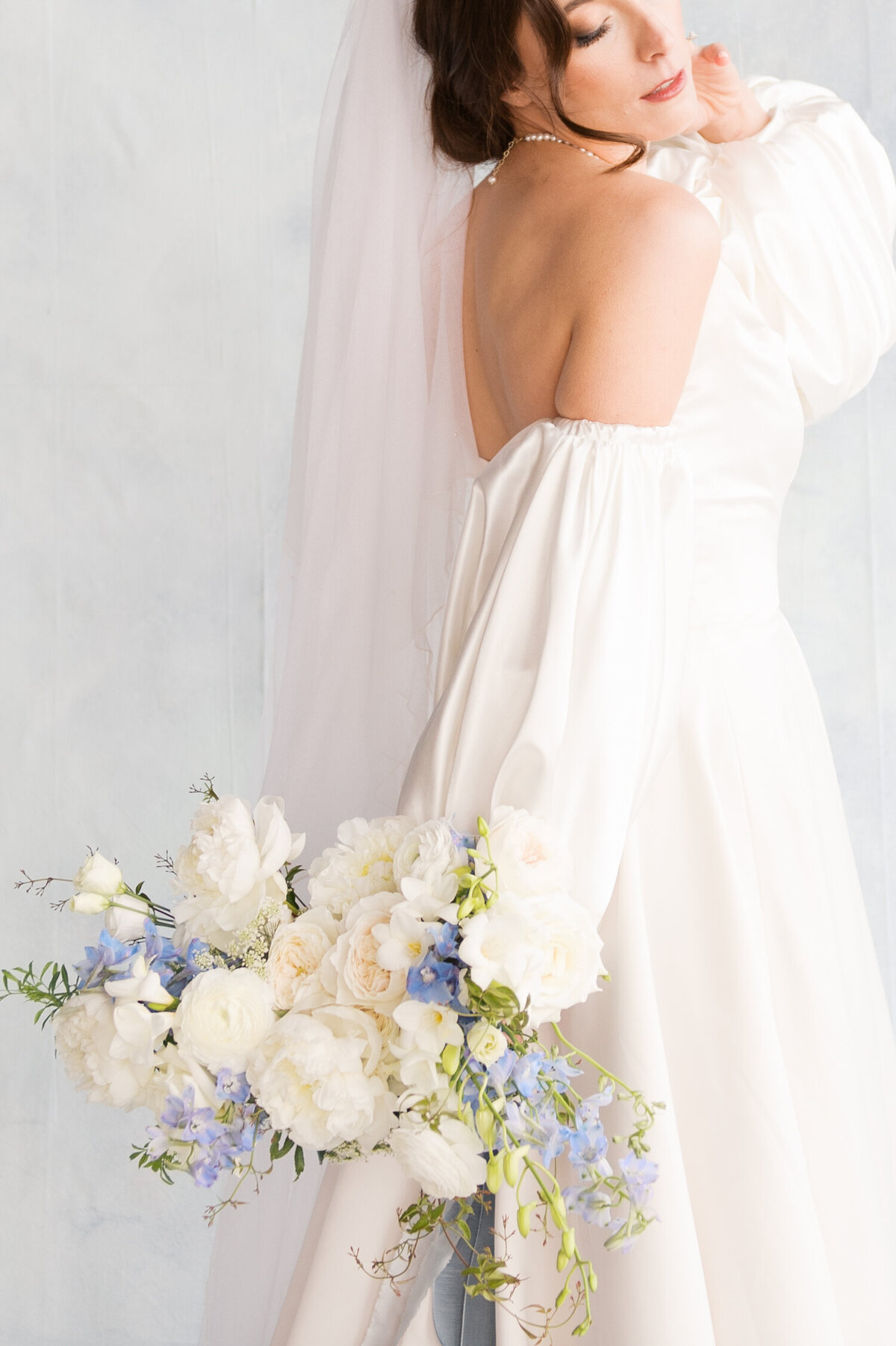 luxury oregon bride holding her trellis floral dusty blue bridal bouquet