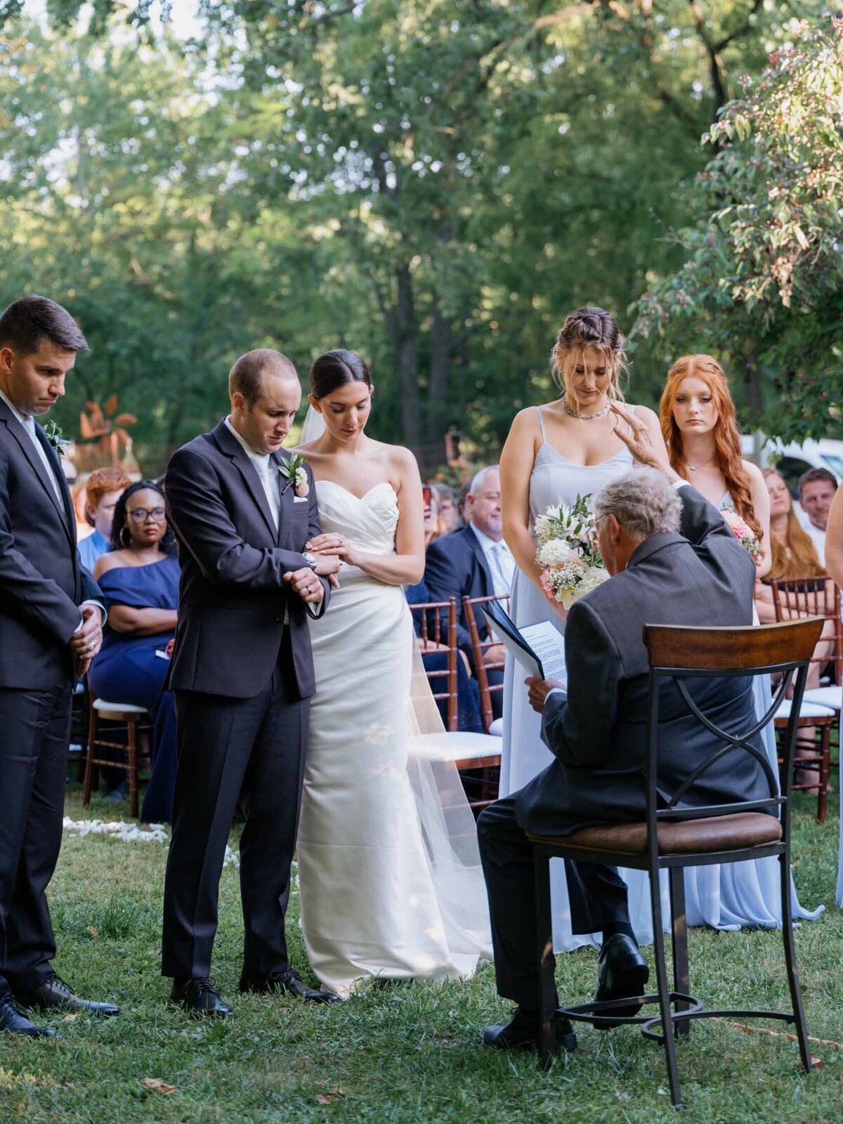 Outdoor wedding ceremony under clear blue sky.