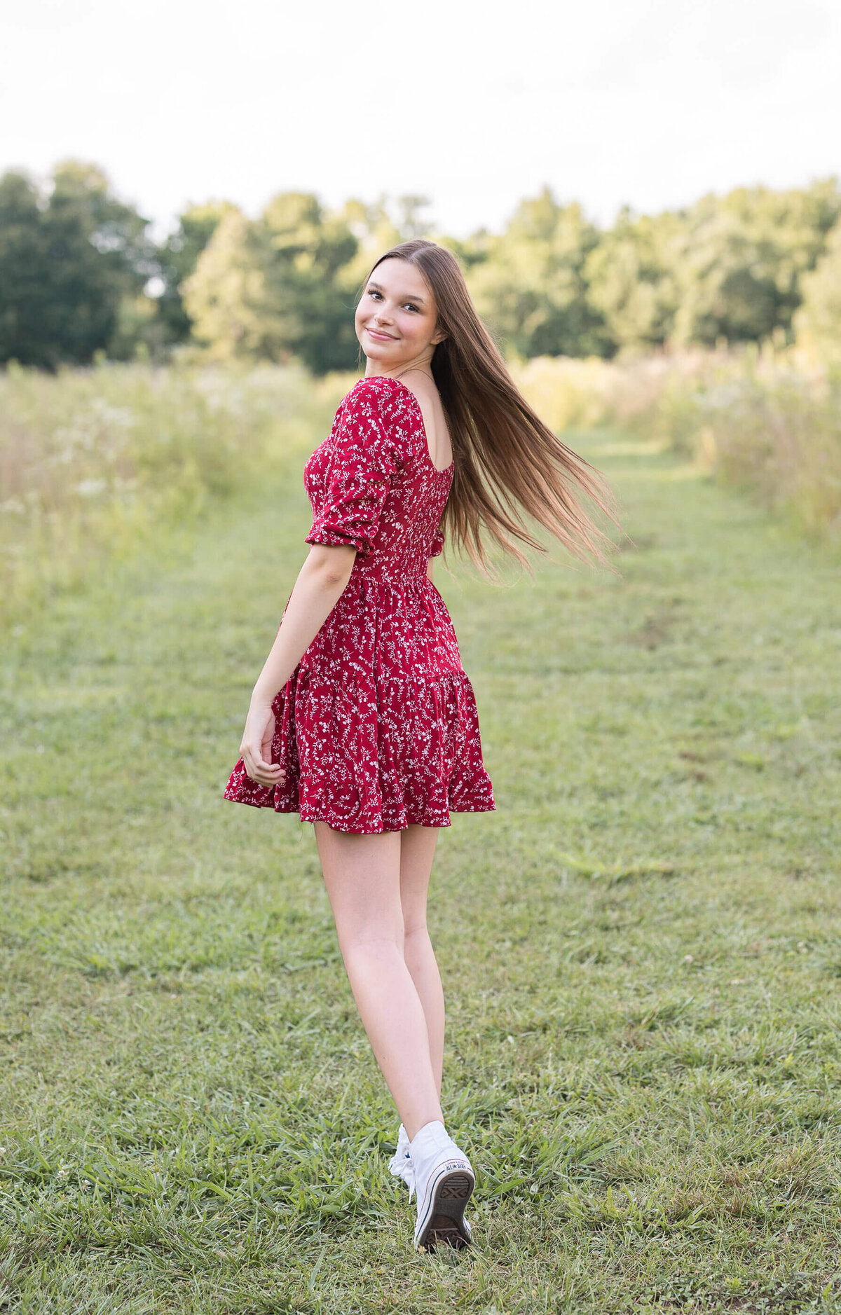 teenager walking in Green Meadows Preserve enjoying her senior session photography by Elizabeth Klusmann Photography