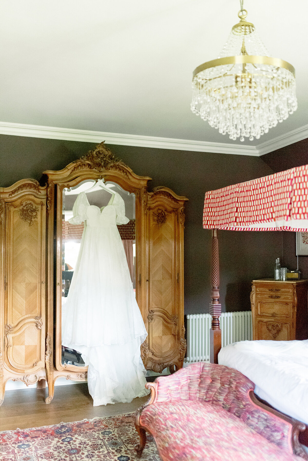 Cromlix House Bridal Suite, wedding dress with puff sleeves hanging on antique wardrobe, Scotland wedding.