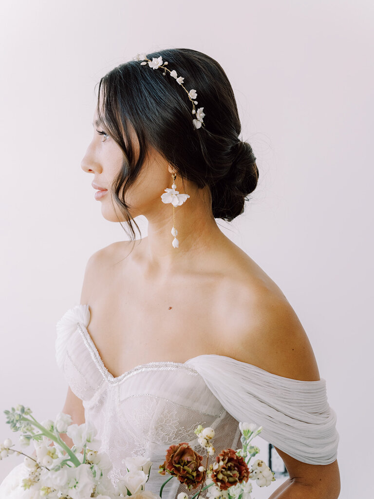 Stunning gold bridal earrings with white flowers, by Joanna Bisley Designs. Photo by Justine Milton. Featured on the Brontë Bride Vendor Guide.