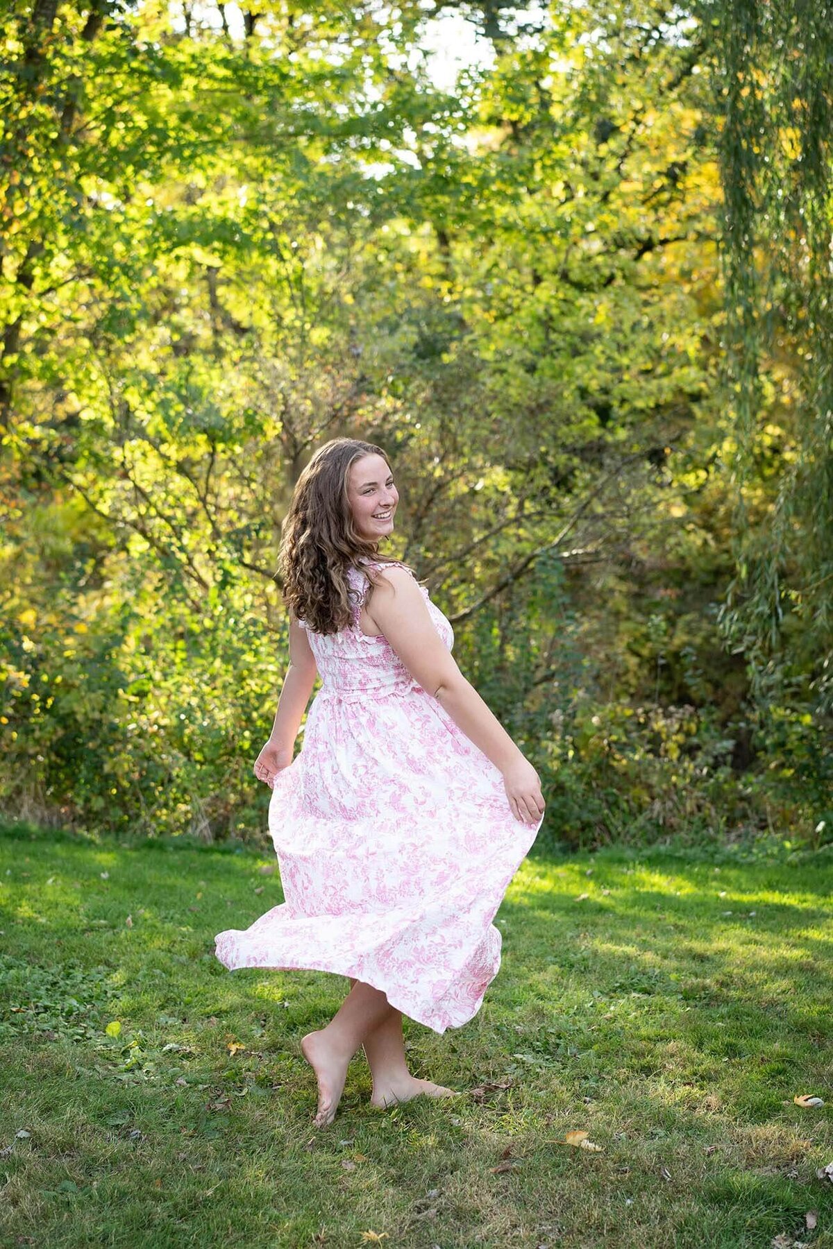 senior-girl-dancing-in-park-with-dress
