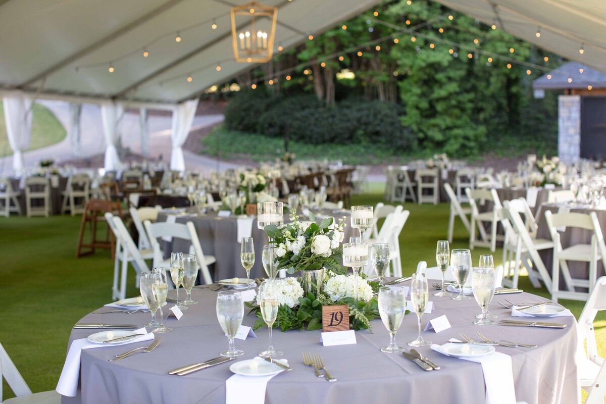 reception tables under tent by Austin wedding photographer Firefly Photography