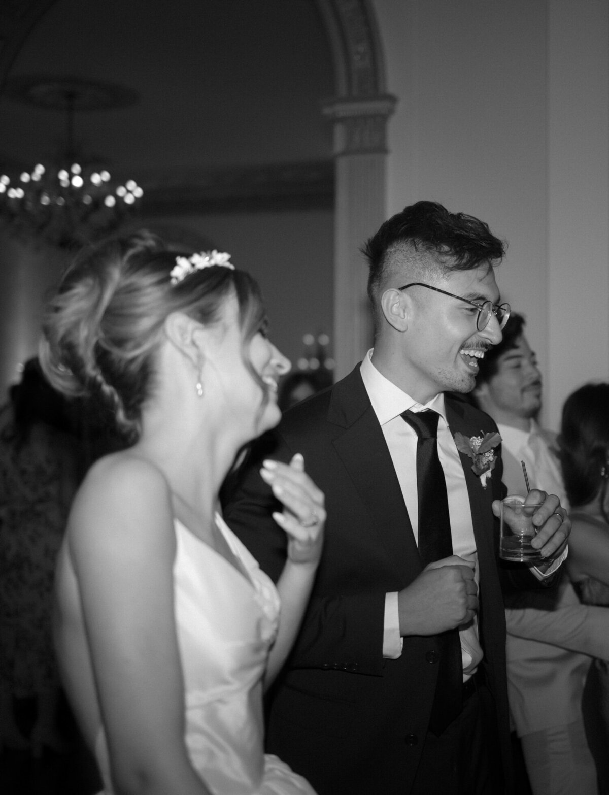 A bride & groom laugh on the dance floor at The Colony Club, unique Detroit wedding reception venue