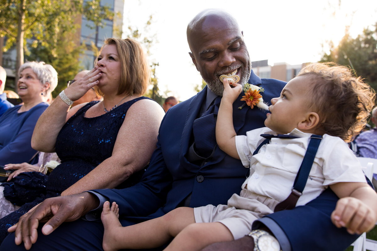 The father of the groom holds his grandson as his wife blows their son a kiss during the wedding ceremony at the Coeur d'Alene Casino near Worley, Idaho.