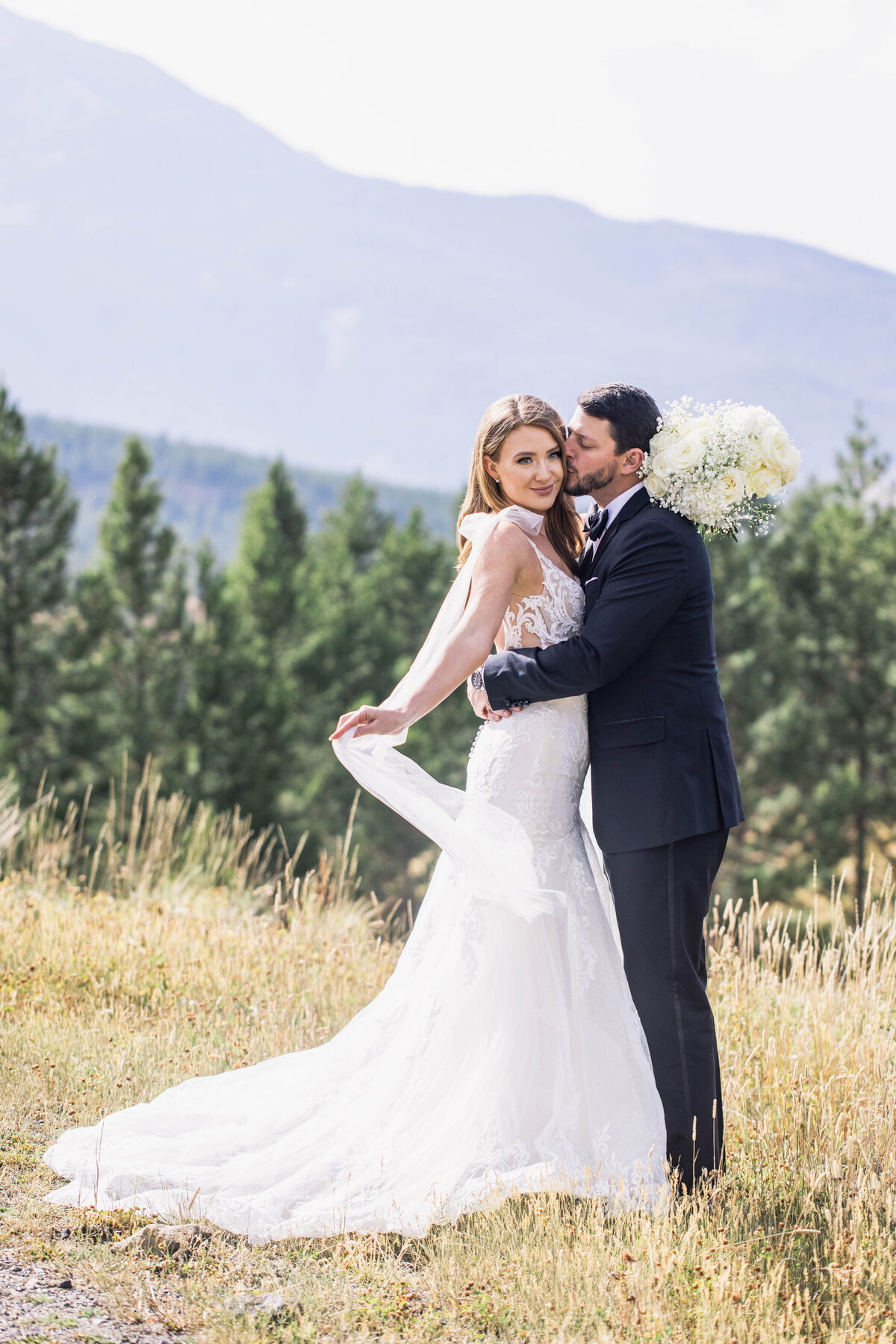 couple embracing in front of mountains