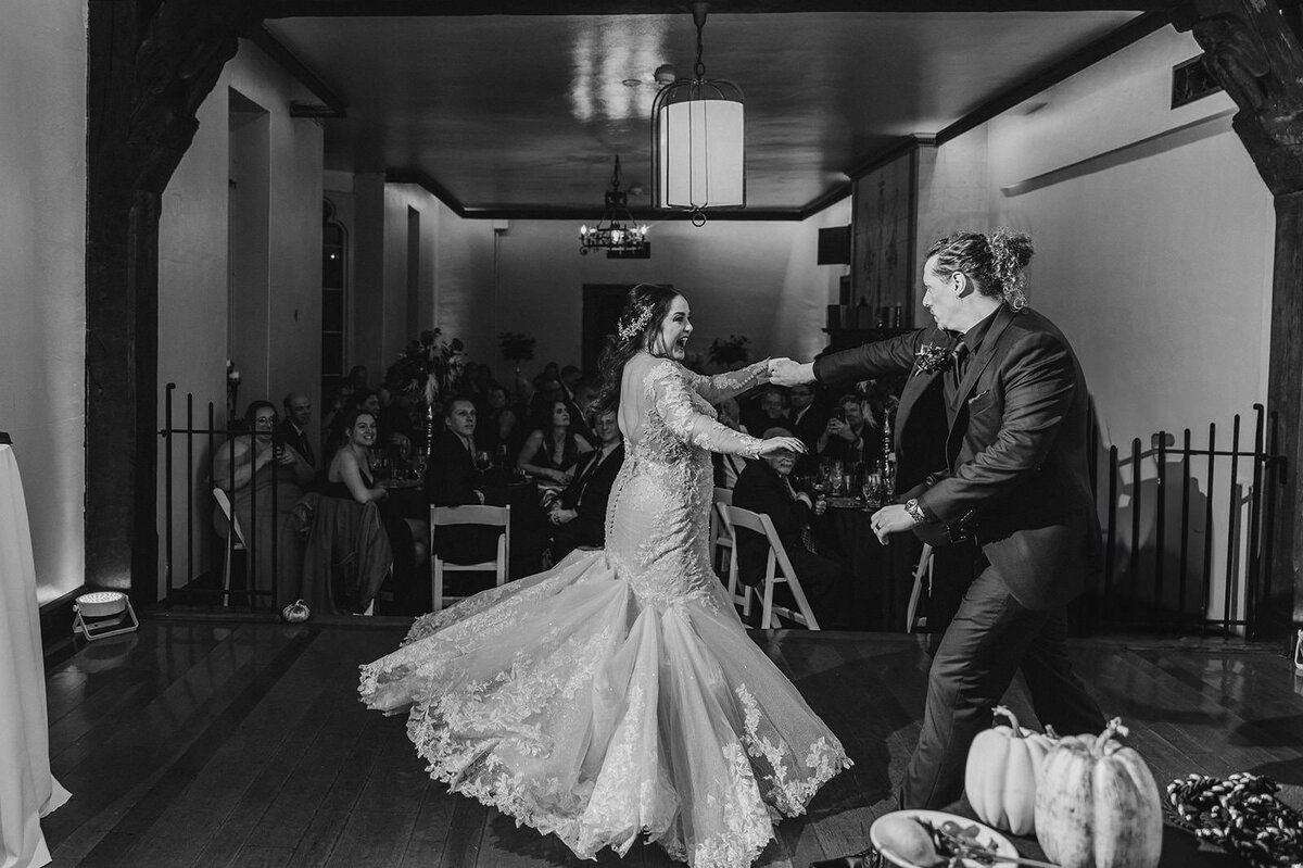 A parent dancing with their child at a wedding reception 
