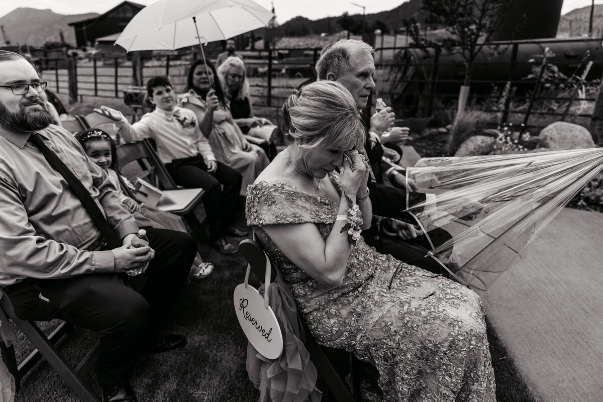 Shannon Lee, from Love Like Wild Photography, captures an emotional guest wiping tears during the wedding ceremony.