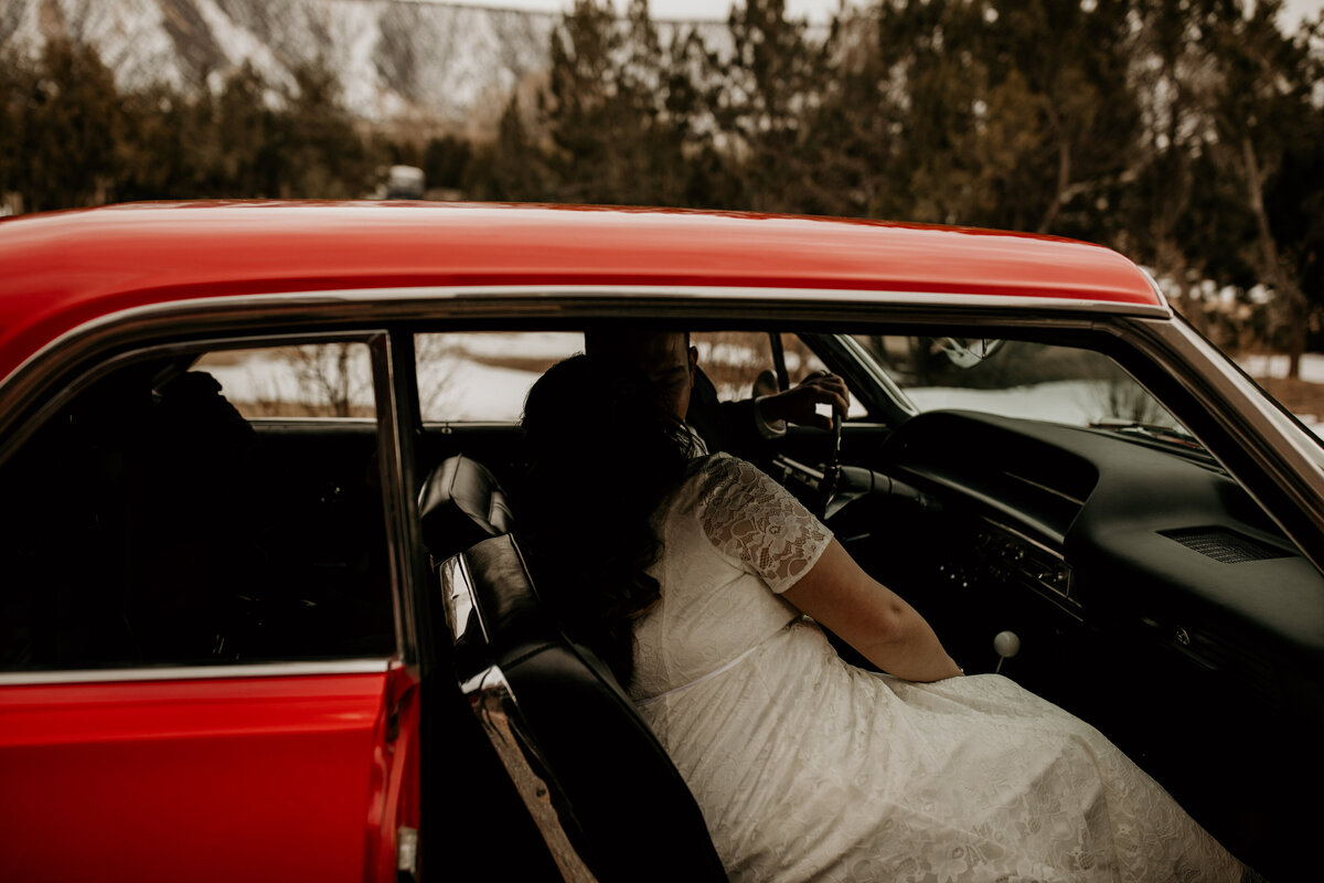 bride and groom sitting in a1963 Cadillac