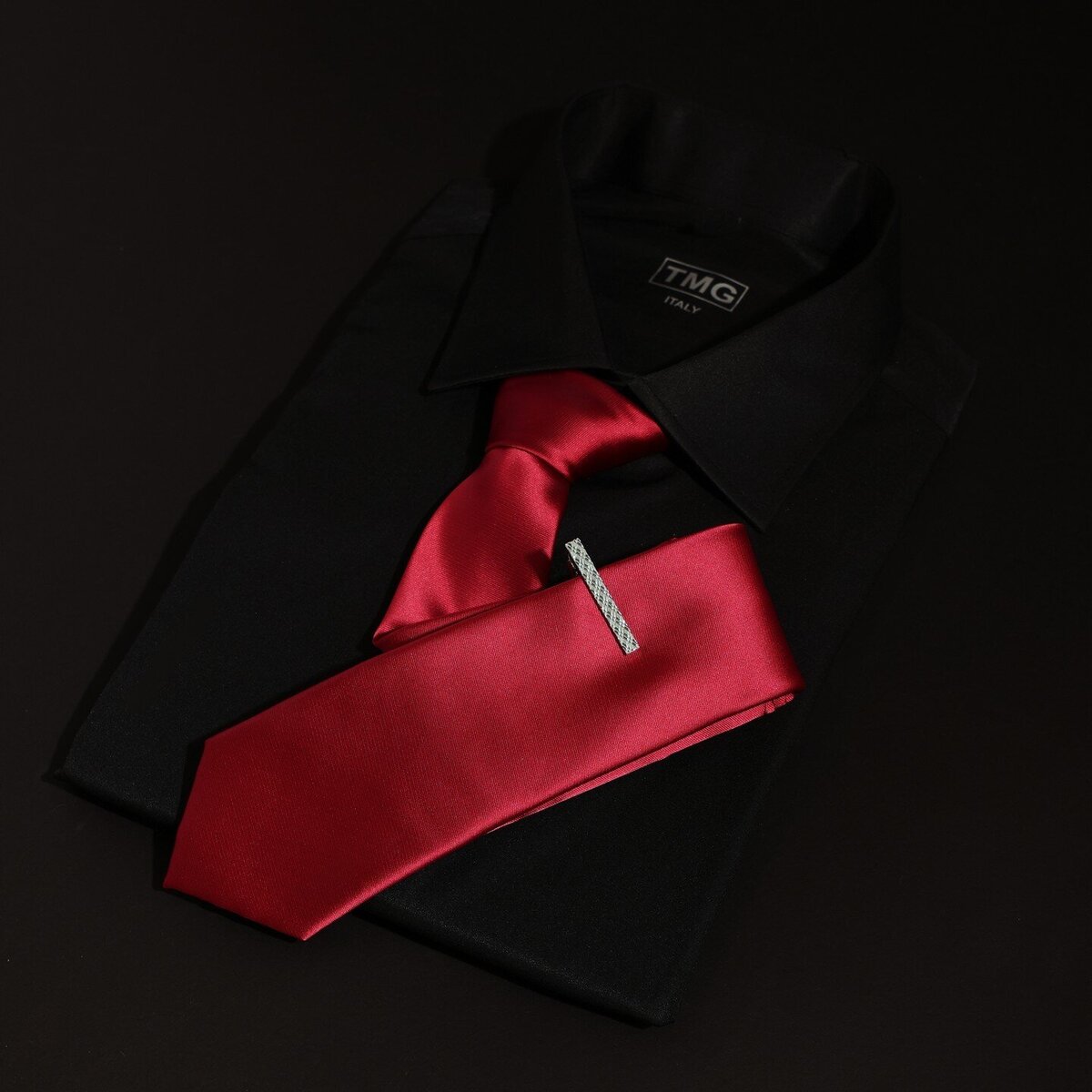 Red tie and black suit jacket representing cocktail attire for men