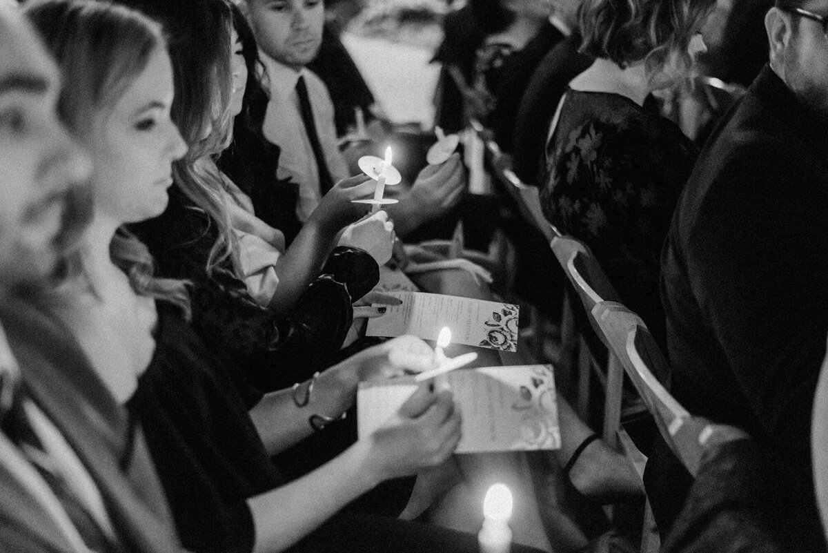 Guests light candles during a heartfelt wedding ceremony in Chicago