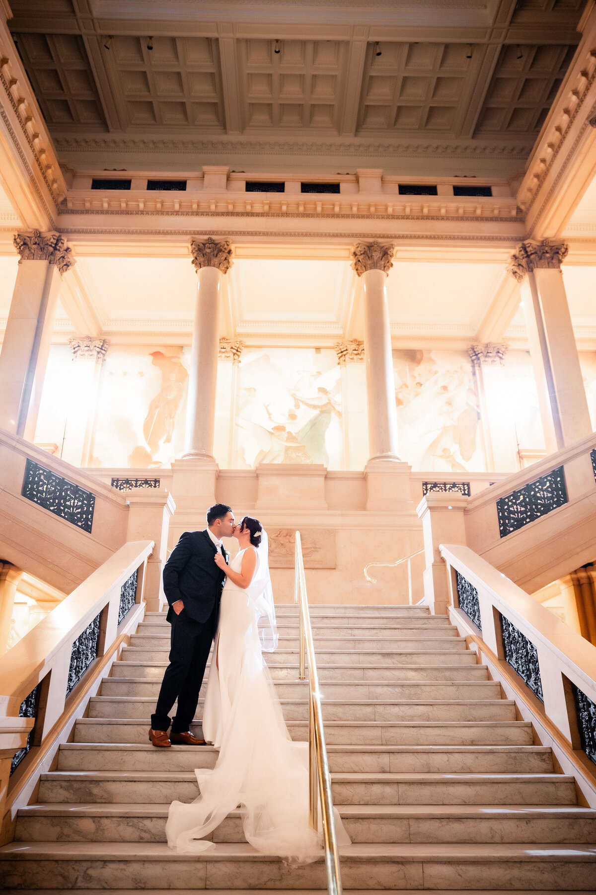 bride and groom at wedding on grand staircase carnegie museum of art pittsburgh