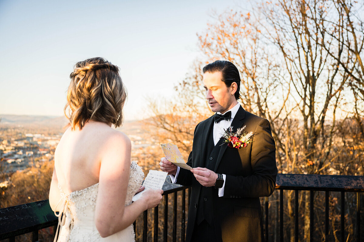 A marrier reads from his vows from a card during their ceremony at the Roanoke Star overlook in Virginia.
