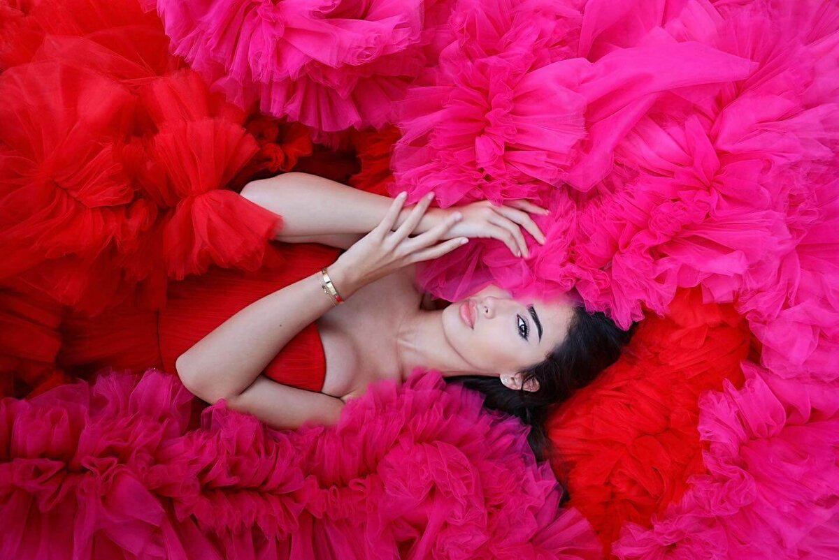 women having a portrait photoshoot in paris wearing a pink princess gown