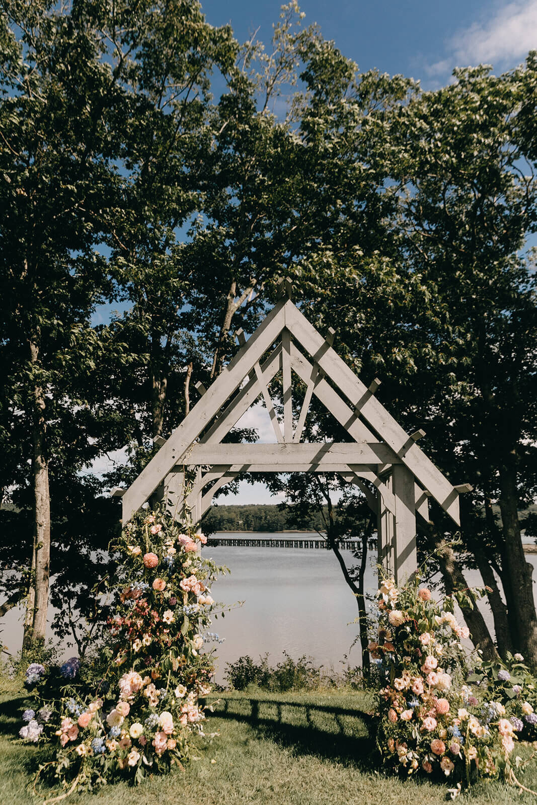 23.waterfront-wedding-ceremony-arch-flowers-pastel-pink-orange-white