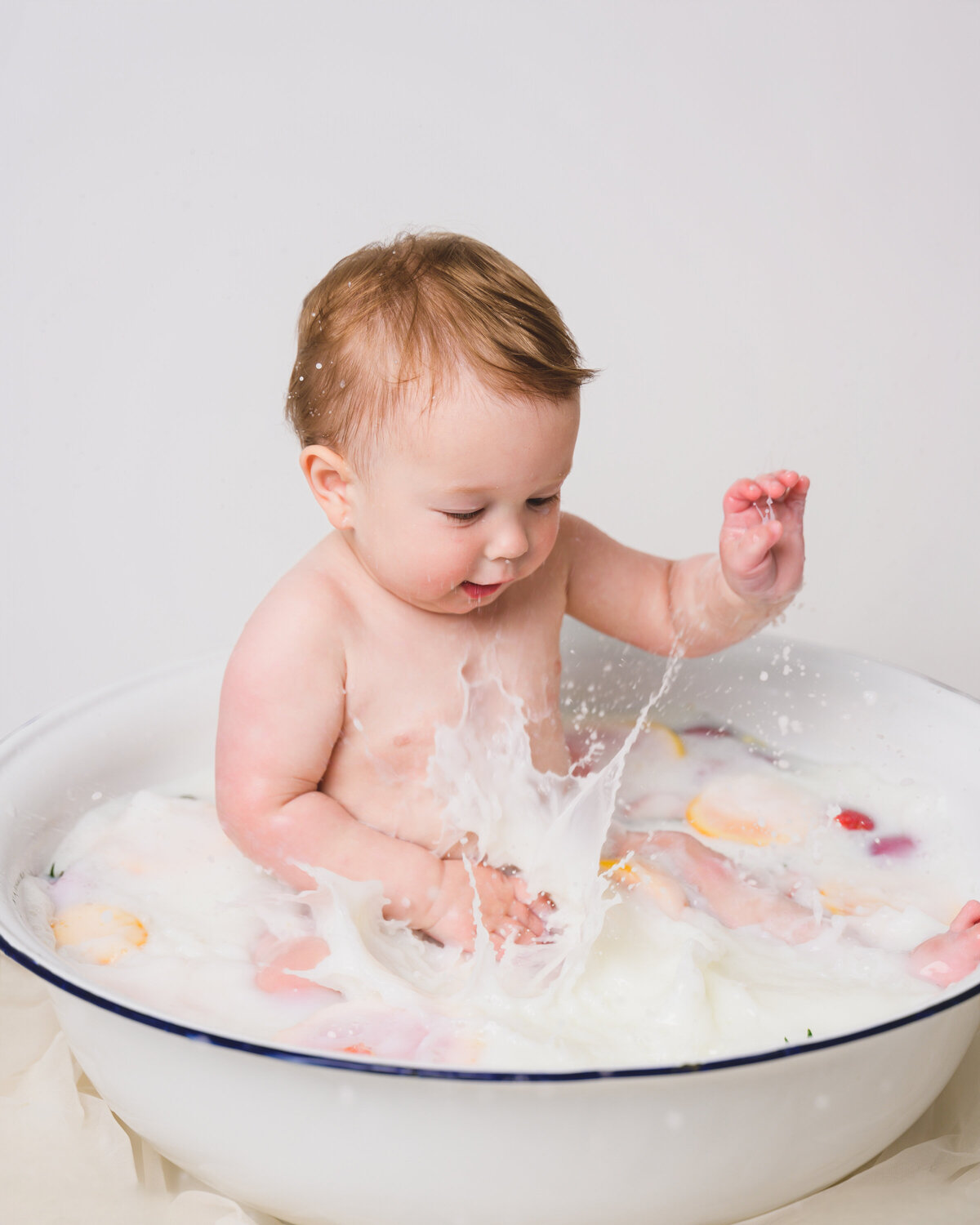 1-year-old in floral milk bath — luxury baby milestone photography in Sausalito
