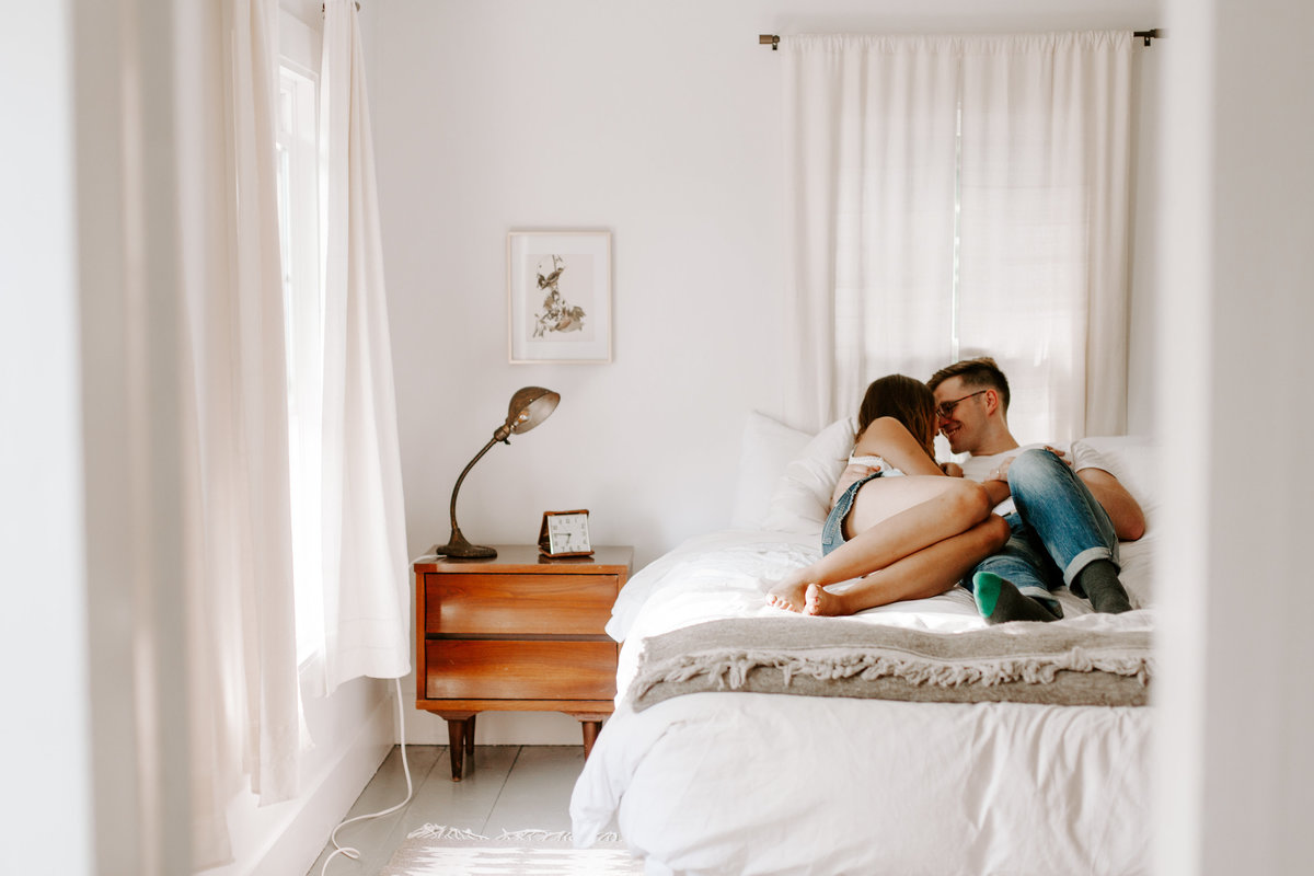 Man and woman snuggling in bed