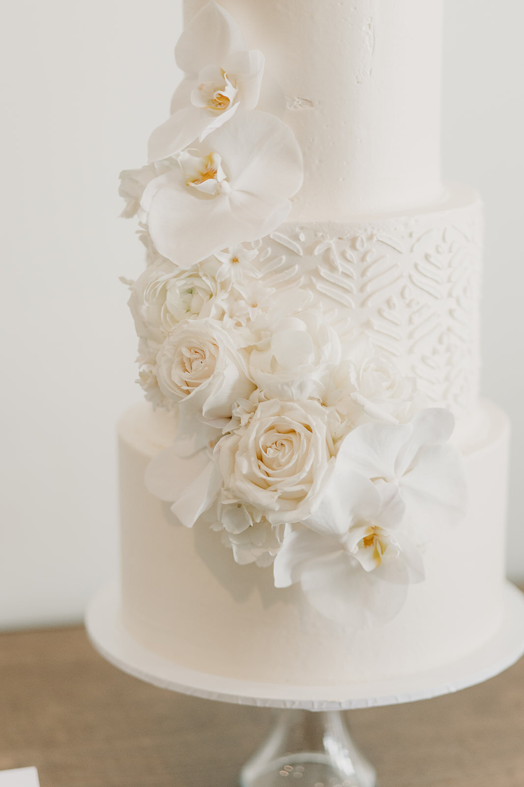 White wedding cake with white flowers and detail