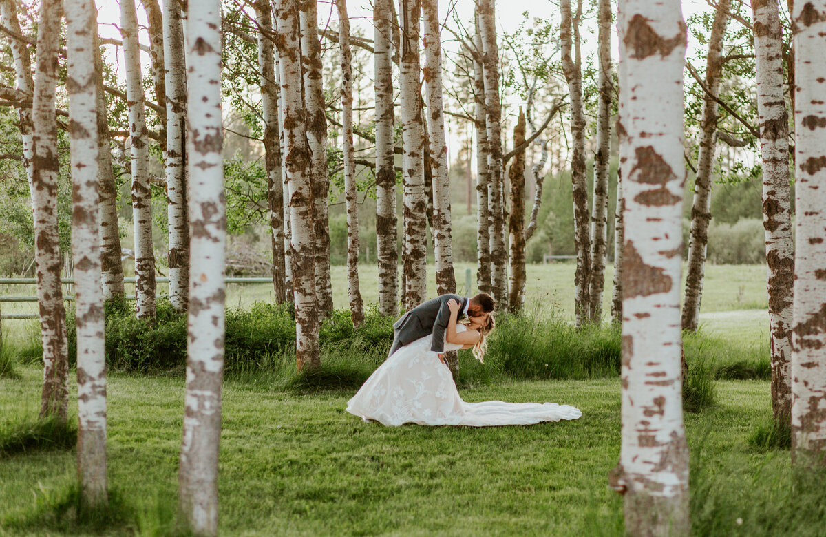 bride and groom kissing in forest '