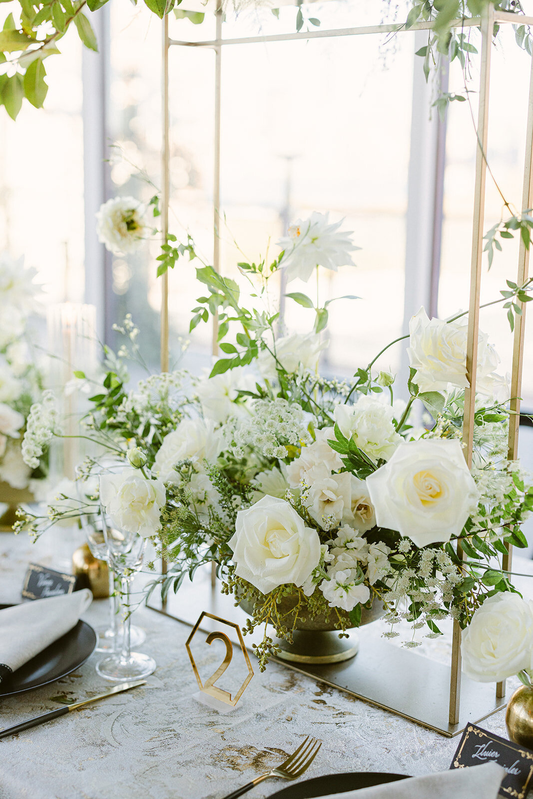 Luxurious wedding table setting with cascading white florals and gold accents