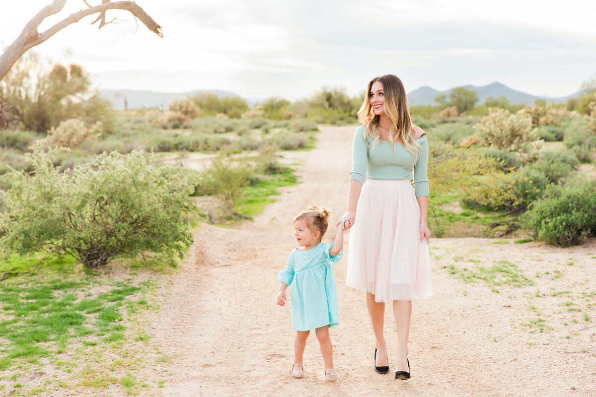 mom and daughter walking together in Phoenix desert