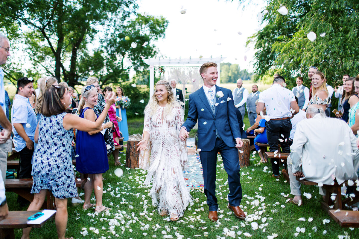 Bride and groom walking togather with joy after getting married at The Cottage Farmhouse