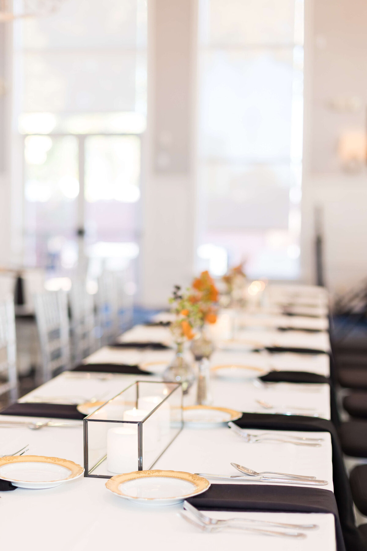 Wedding reception tables with florals and black napkins at The Carrick House Wedding venue in Lexington, KY