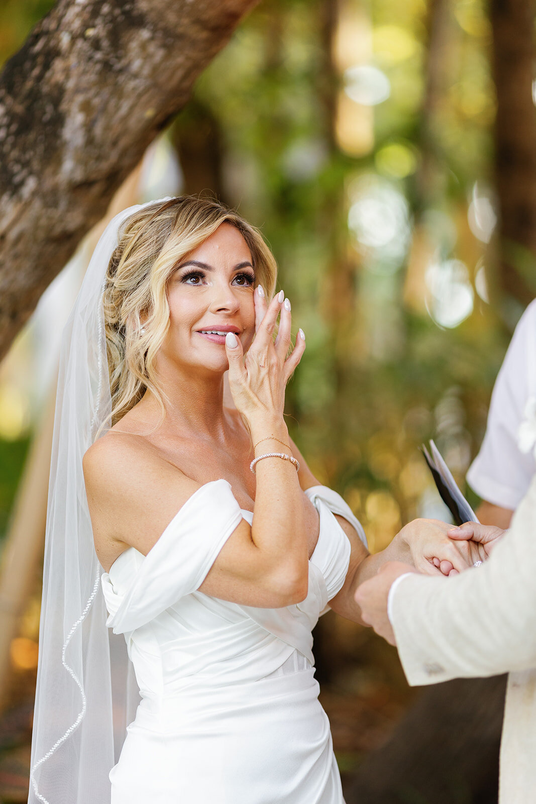 Monica wipes a tear as she shares heartfelt vows with Austyn at their Casitas at Cheeca micro wedding.