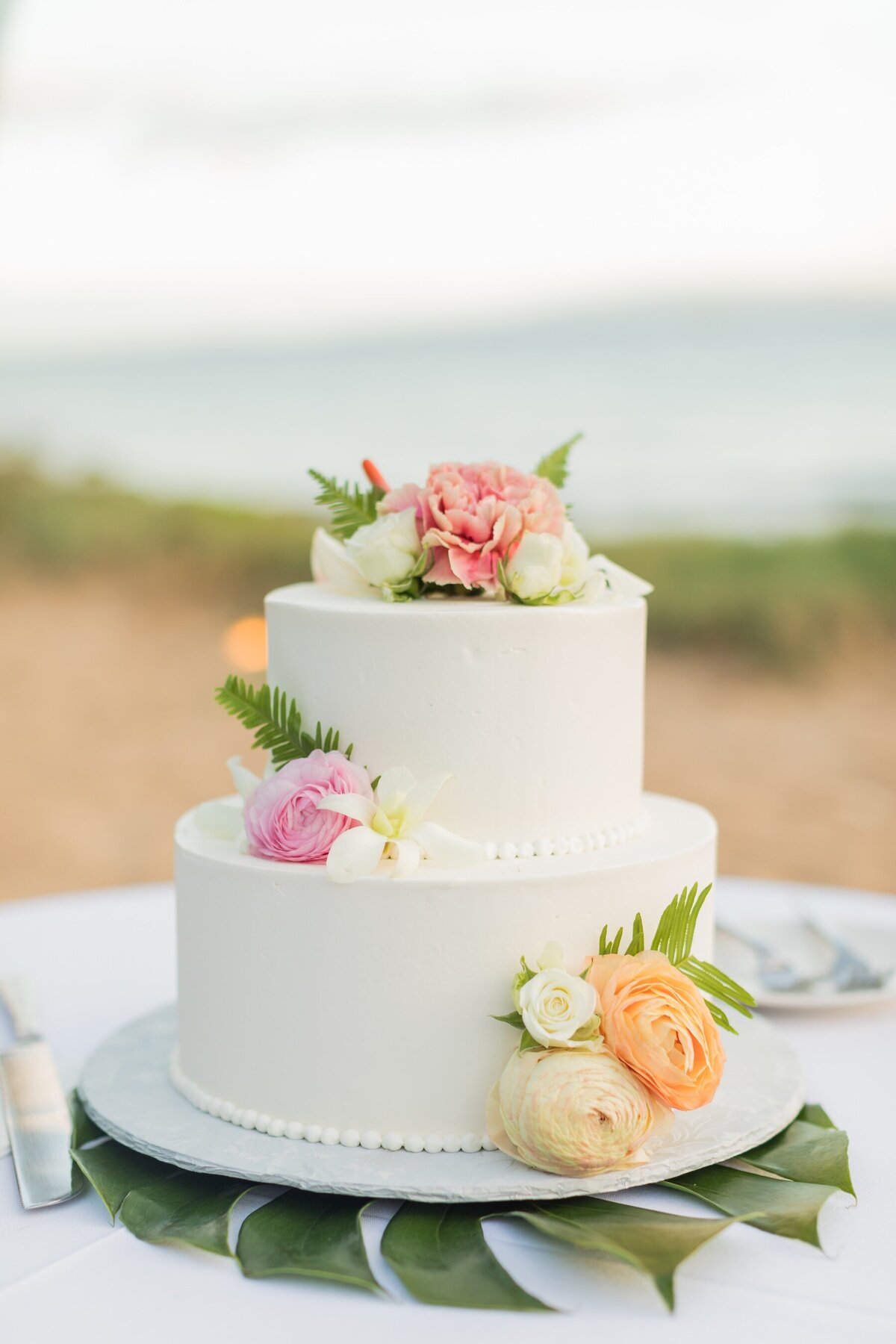 two tier Maui Wedding cake with cake flowers