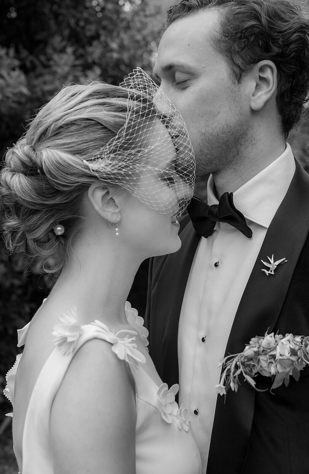 Groom kisses brides forehead
