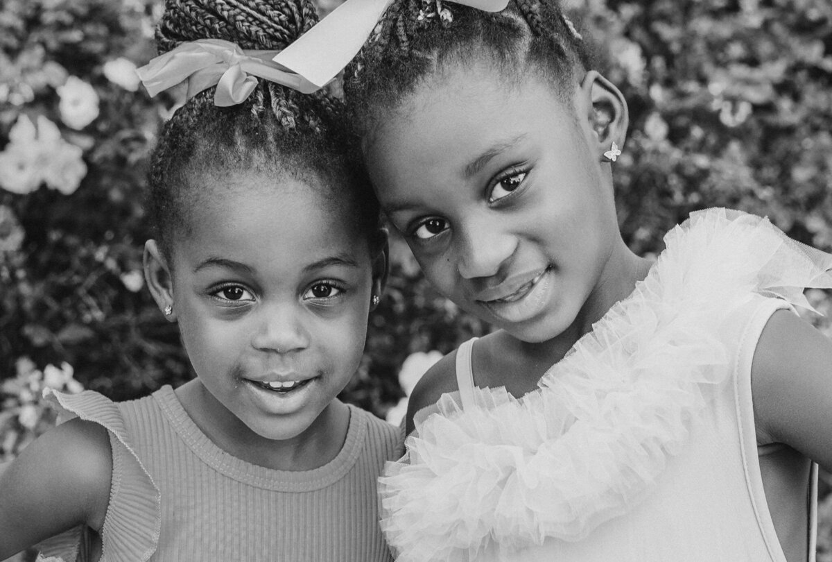 Siblings standing close together and smiling 