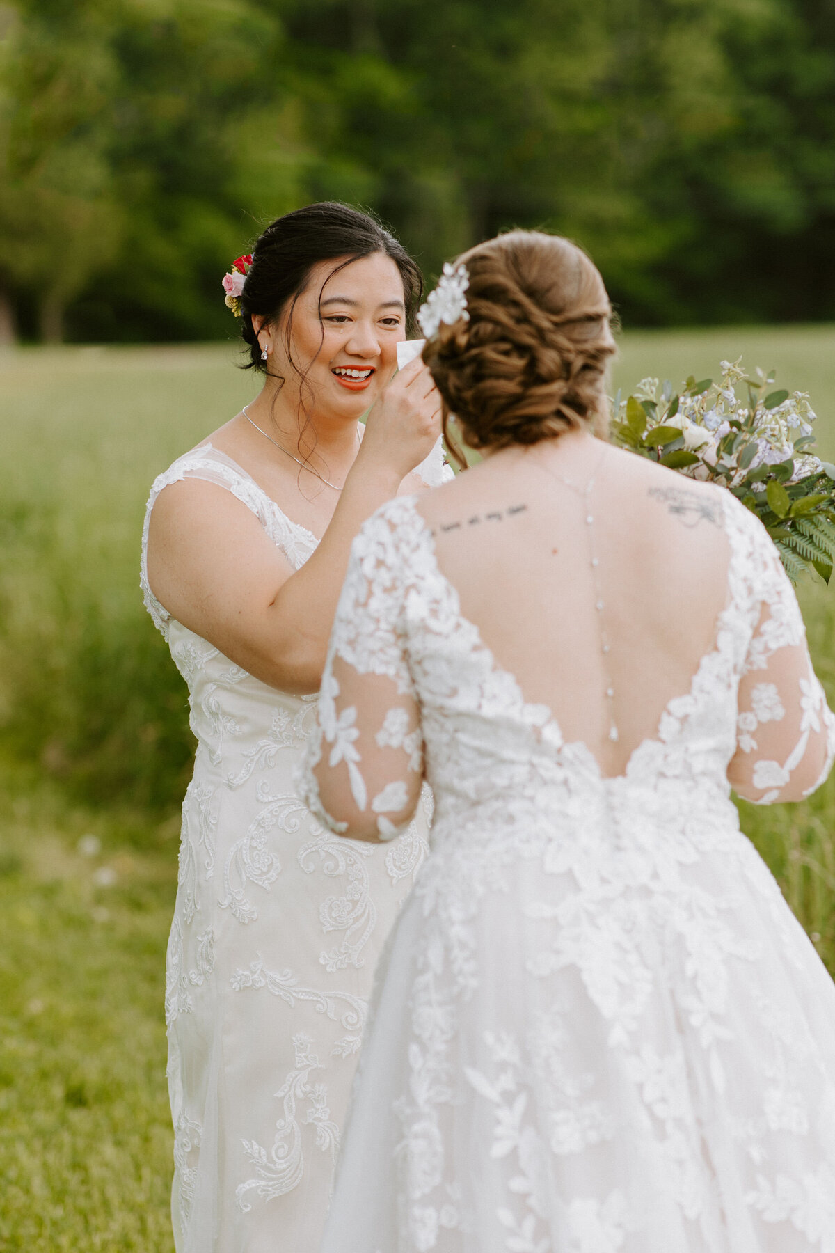 two brides smiling and looking at each other