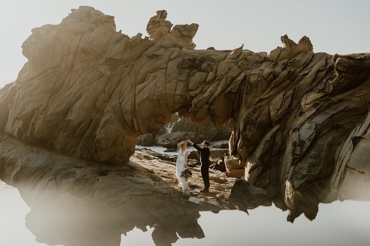 Bride and groom walking in Sonoma County's Armstrong Redwoods during their adventure elopement