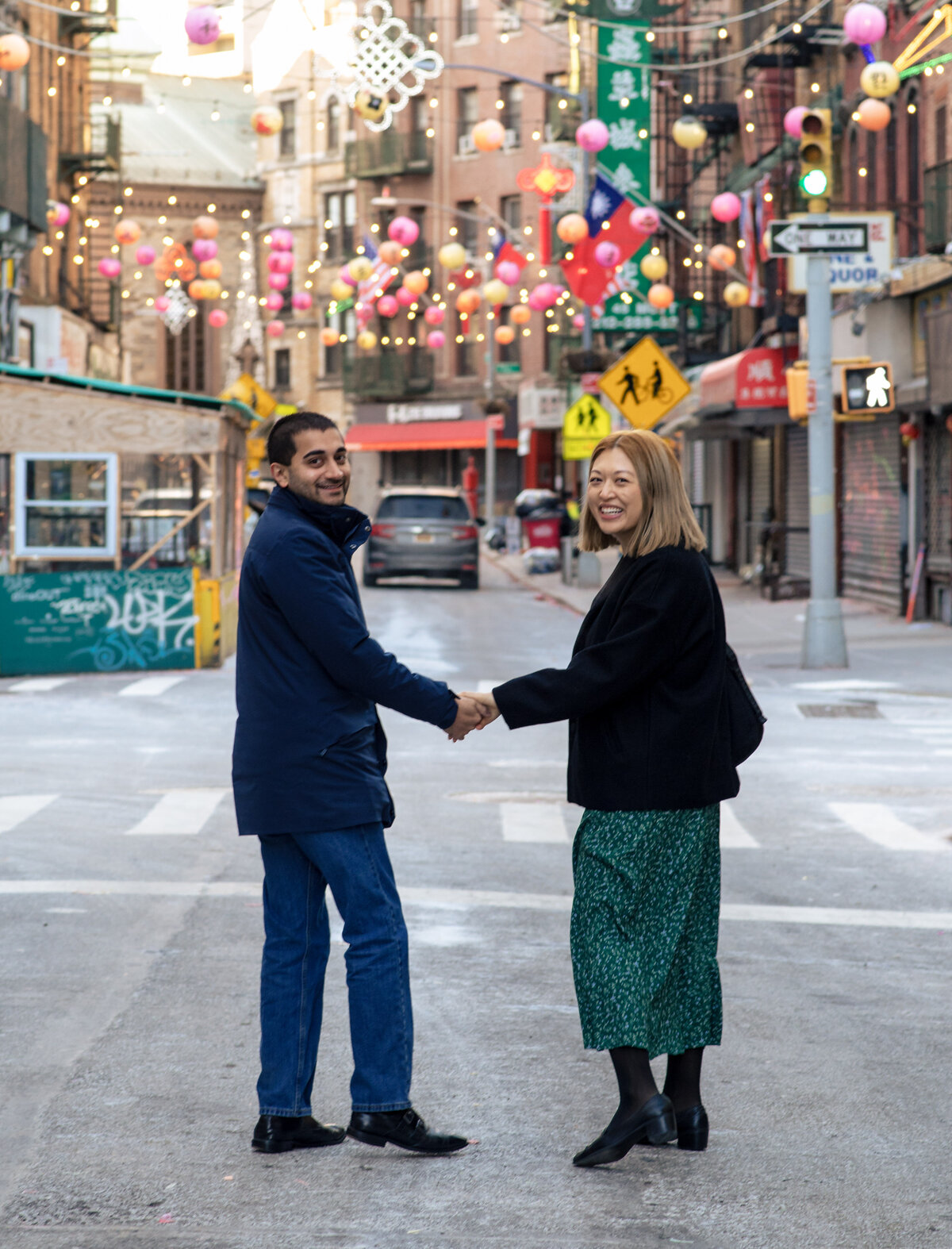 Inter-racial couple, a Chinese girlfriend and Indian boyfriend strolling thru Chinatown's New Year's lanterns display.