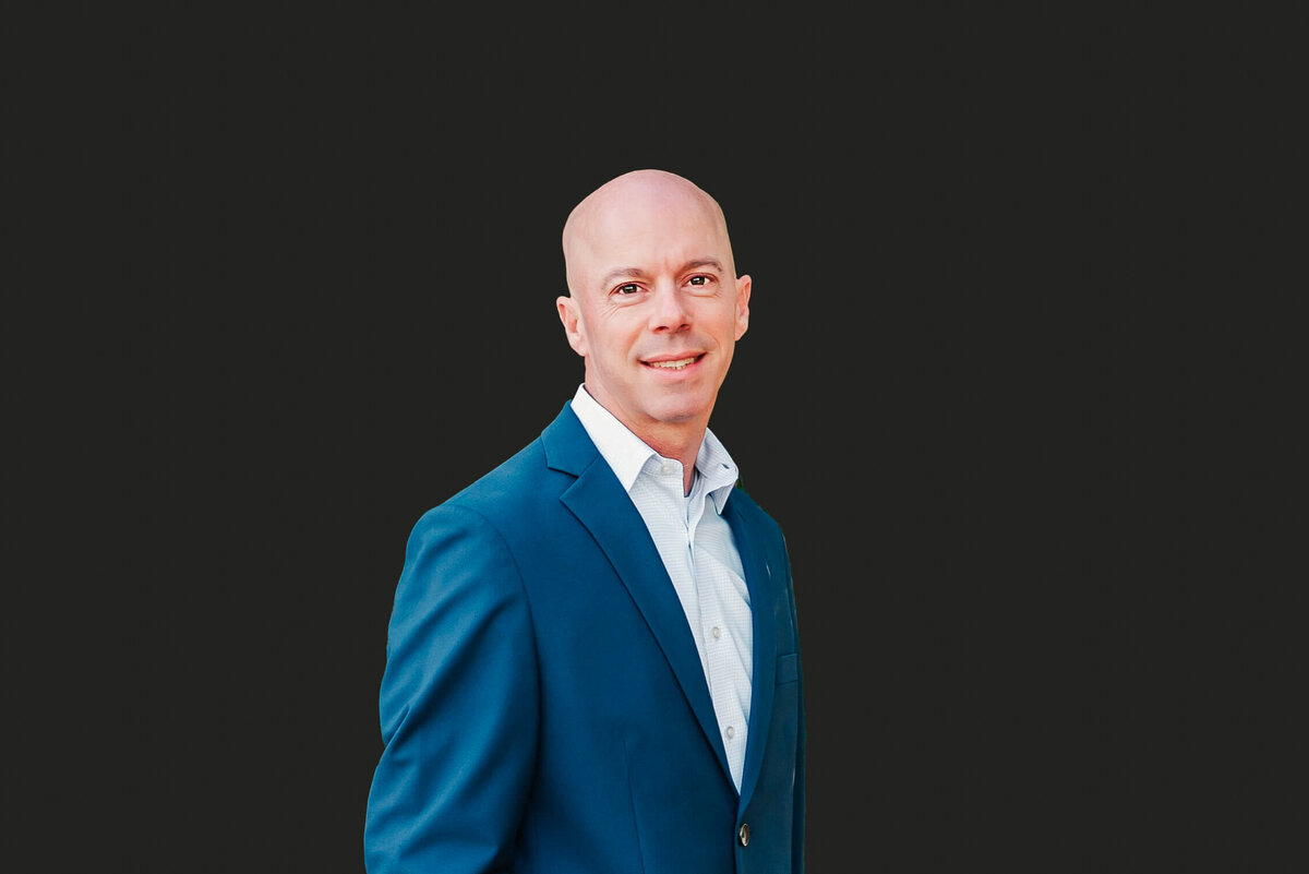 Branson Missouri headshot photographer The XO Photography captures closeup headshot of man against black background