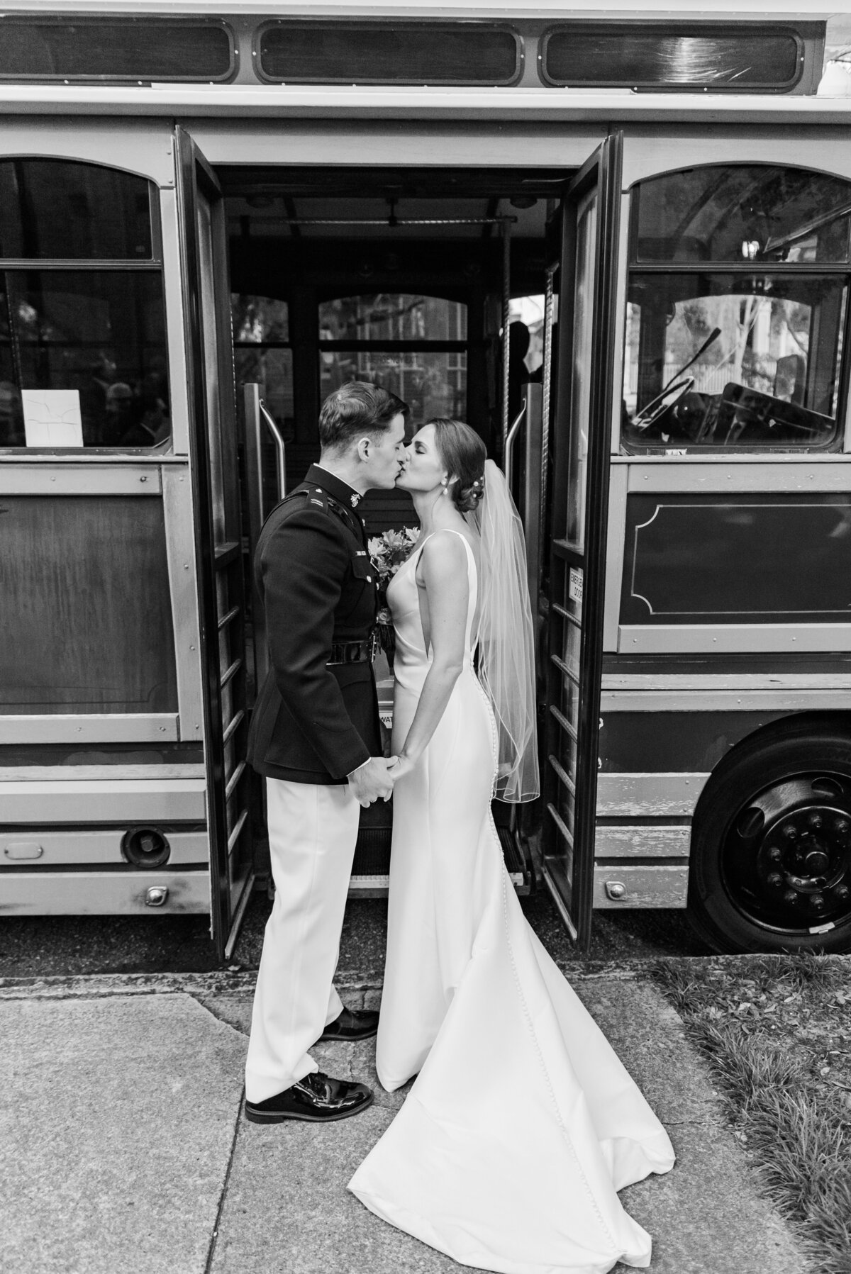 bride and groom kissing with trolley