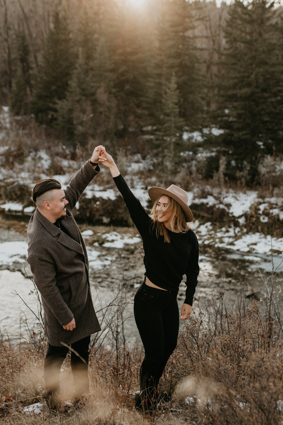 Couple dancing in the mountains at sunset captured by Nikki Collette Photography, adventurous and romantic wedding photographer in Red Deer, Alberta. Featured on the Bronte Bride Vendor Guide.