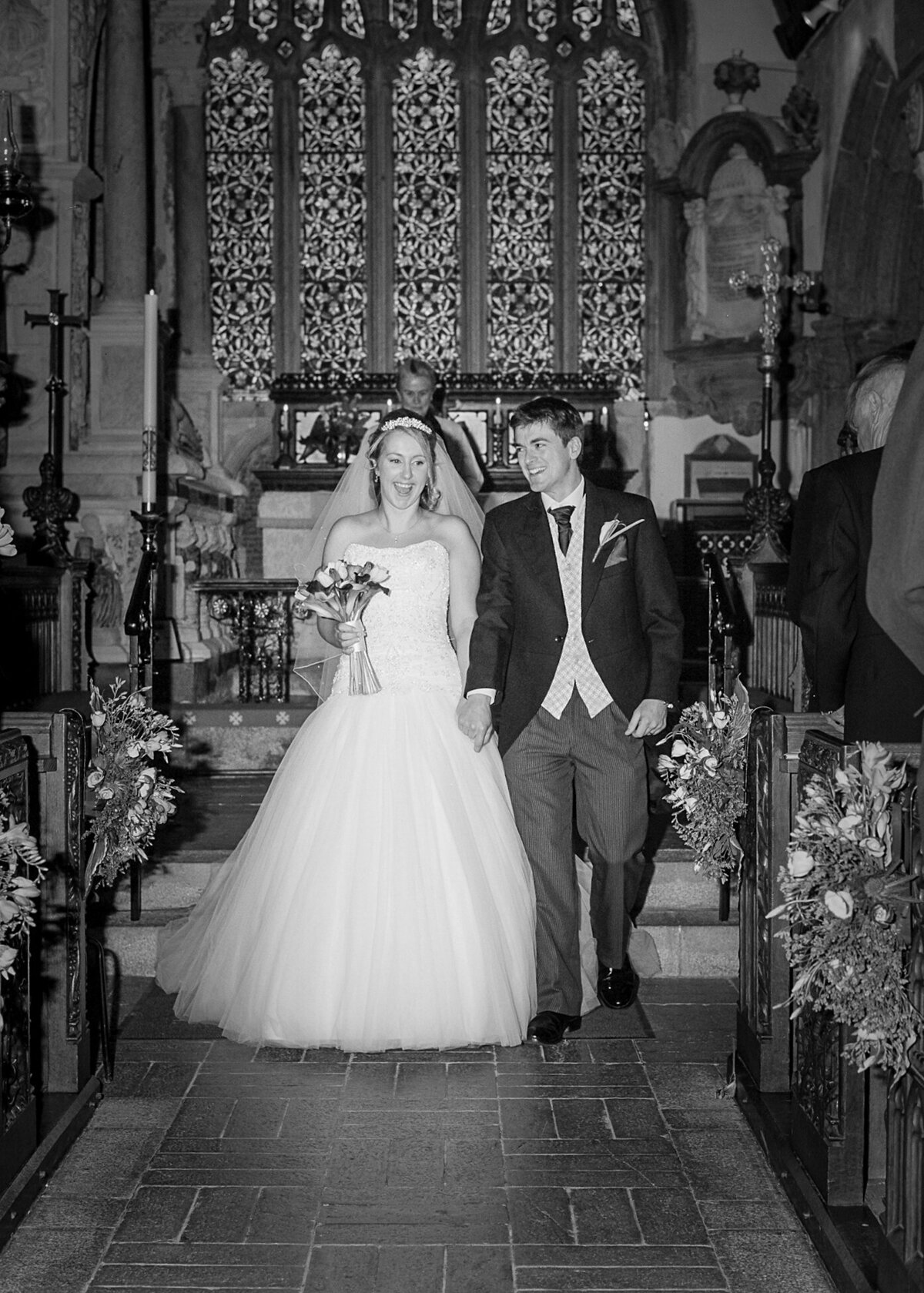 pro-story-photography_bride&groom-walking-up-aisle_wembury-church_devon