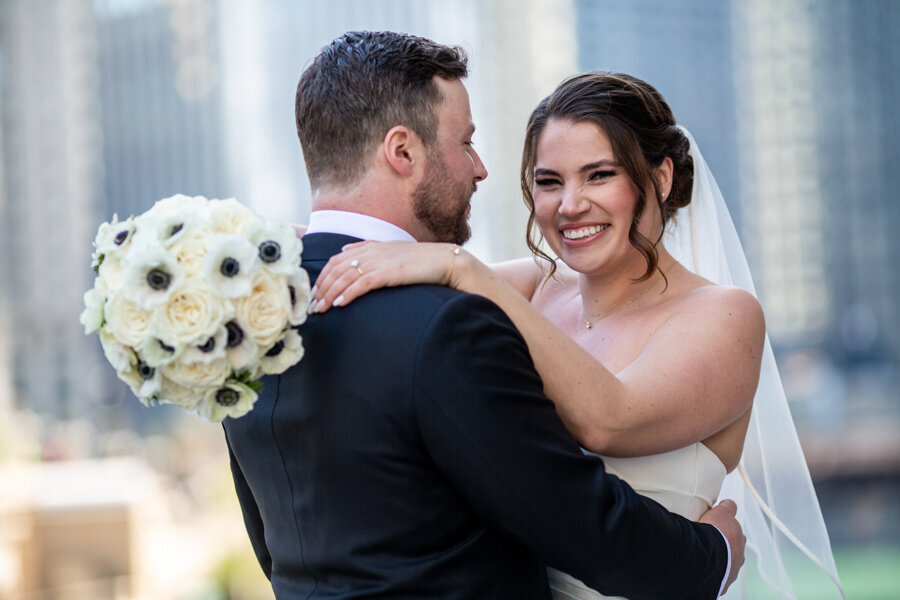 bride-looking-bouquet-chicago-river-hbicweddings