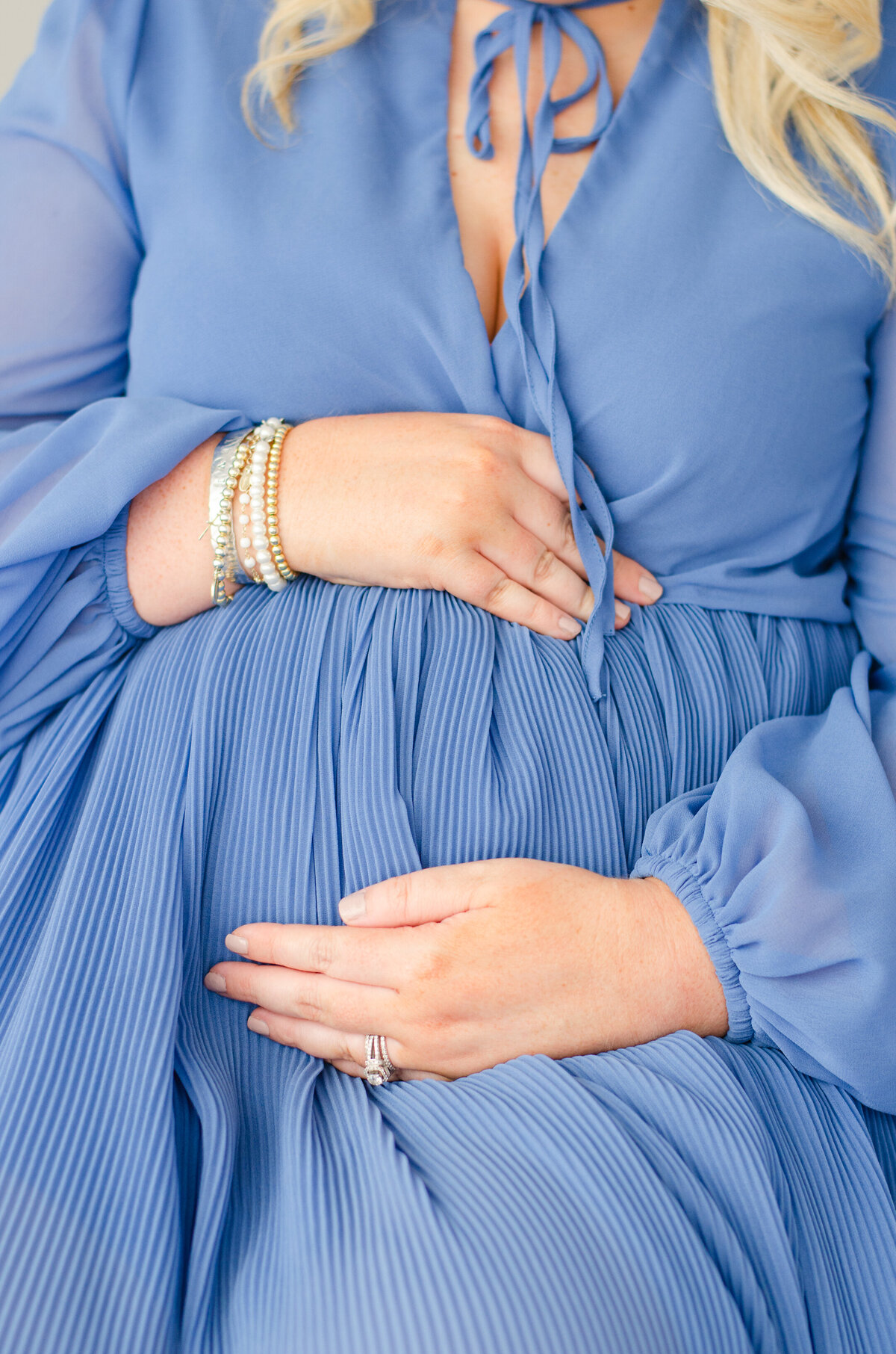 close up of expecting mother holding her belly bump