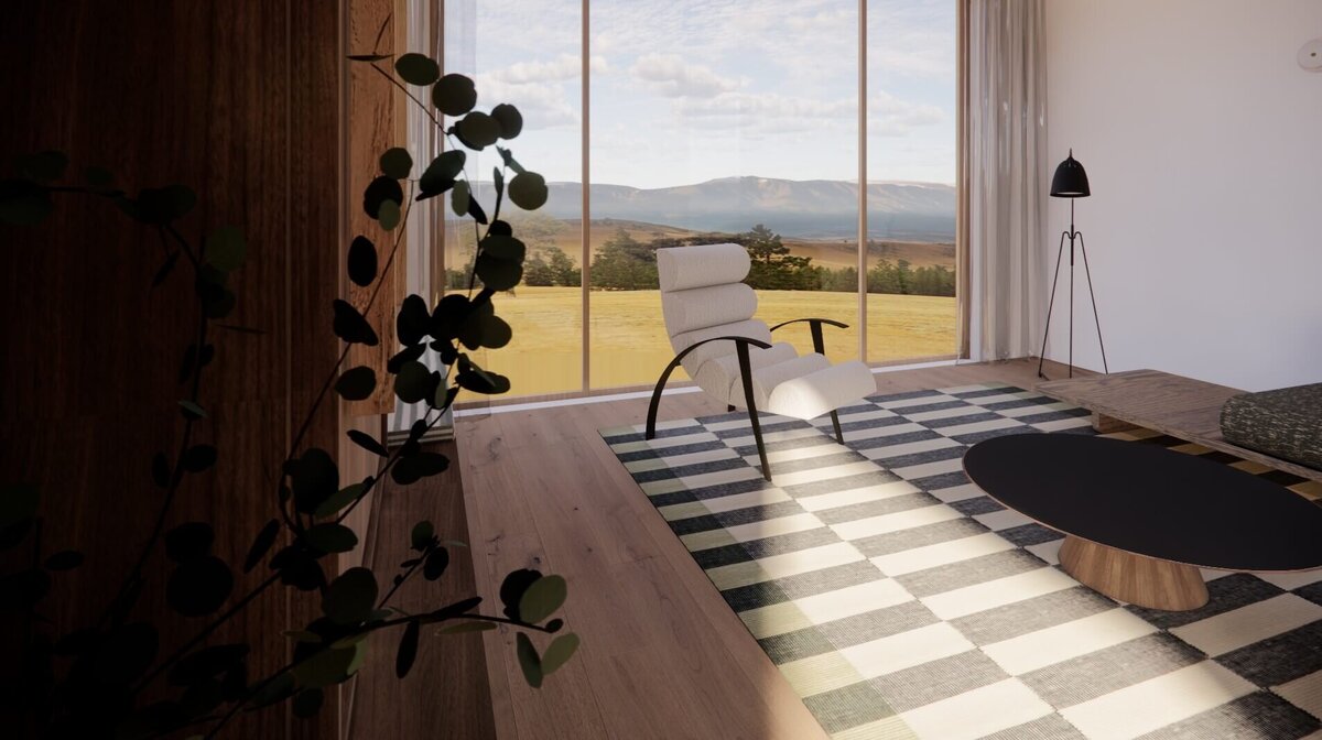 A living room with a vintage armchair, black lamp and round walnut coffee table.