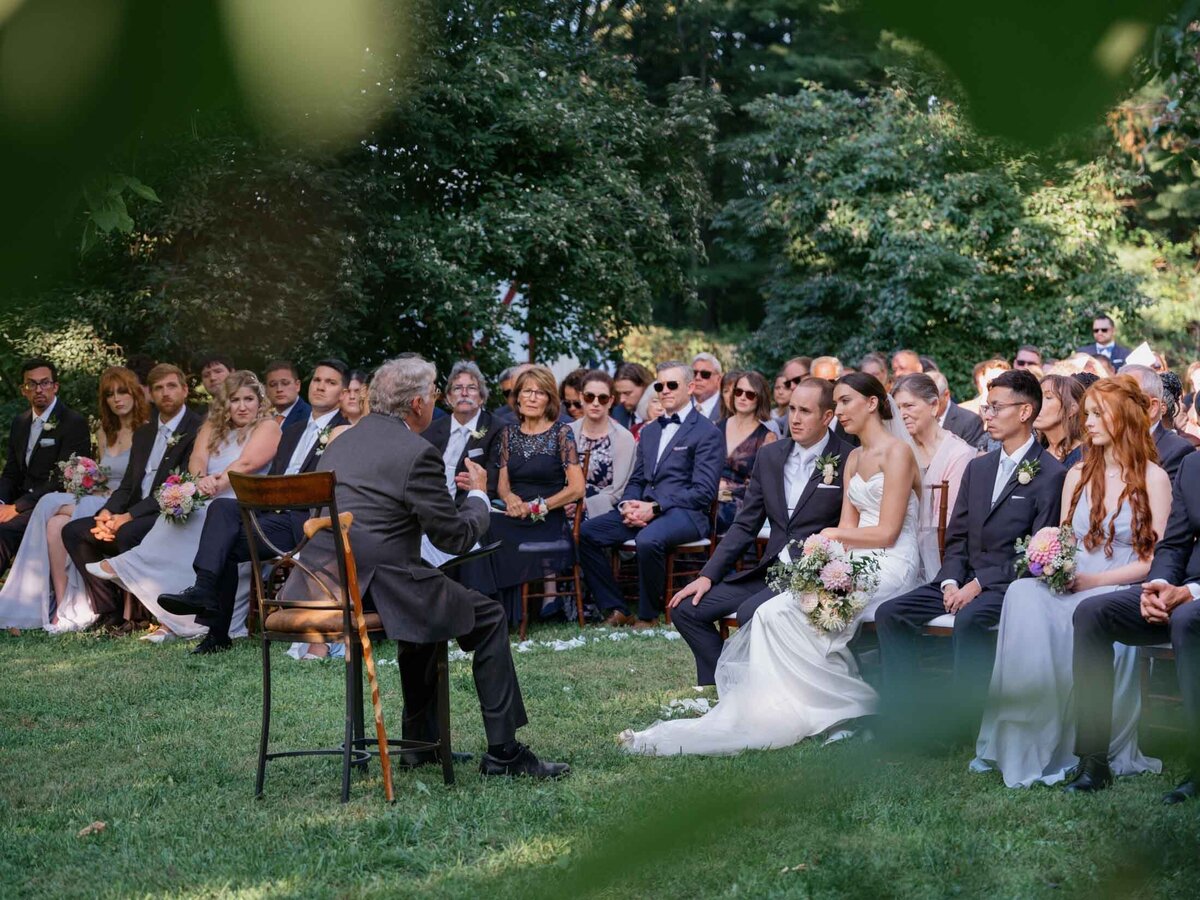Outdoor wedding ceremony under clear blue sky.