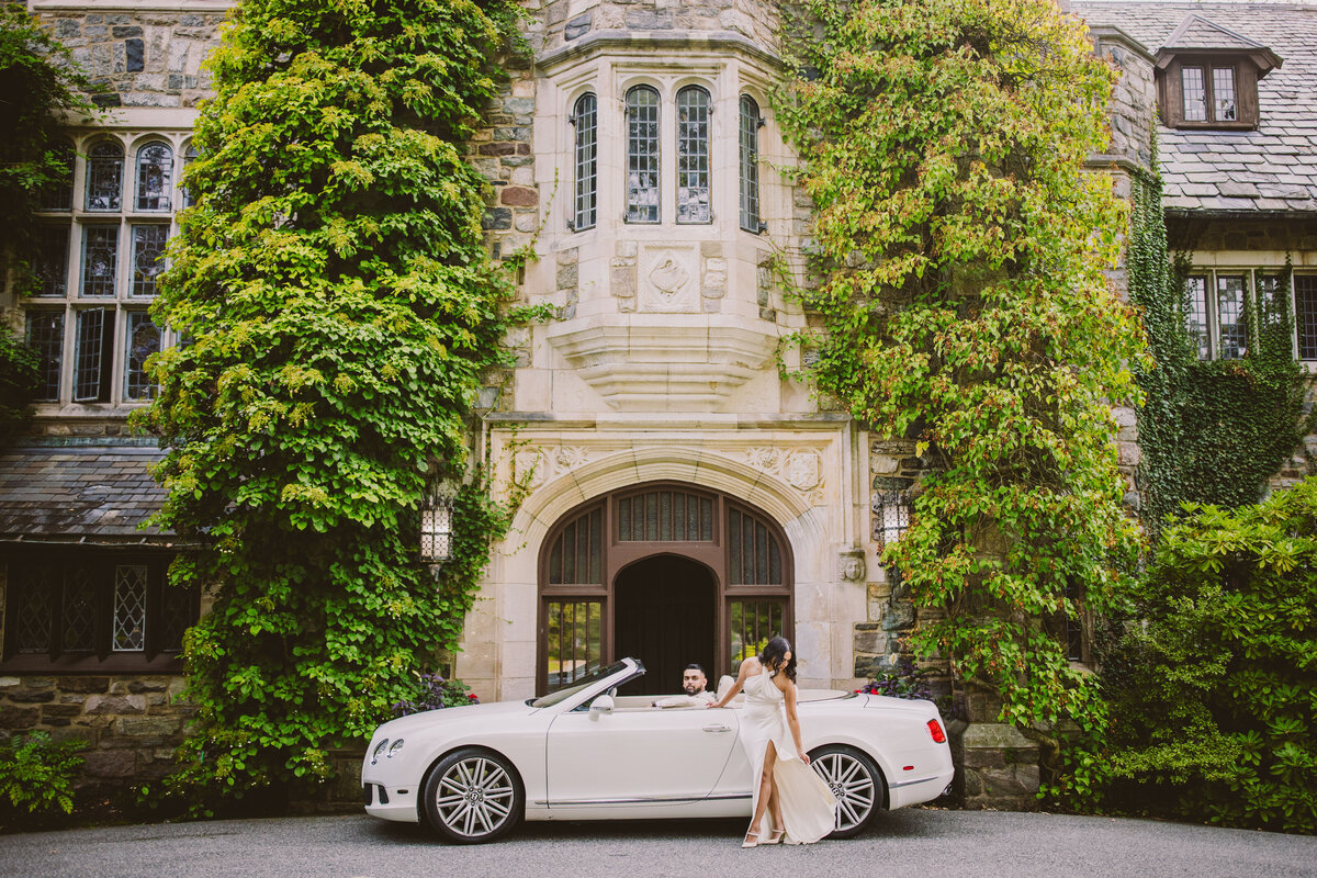 A couple posing in front of a car at the skylands manor