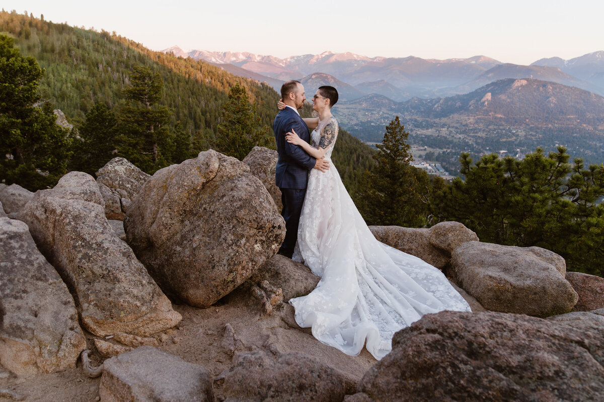 Couple snuggles at sunrise for their elopement in colorado with alpine vows in Estes Park, Colorado