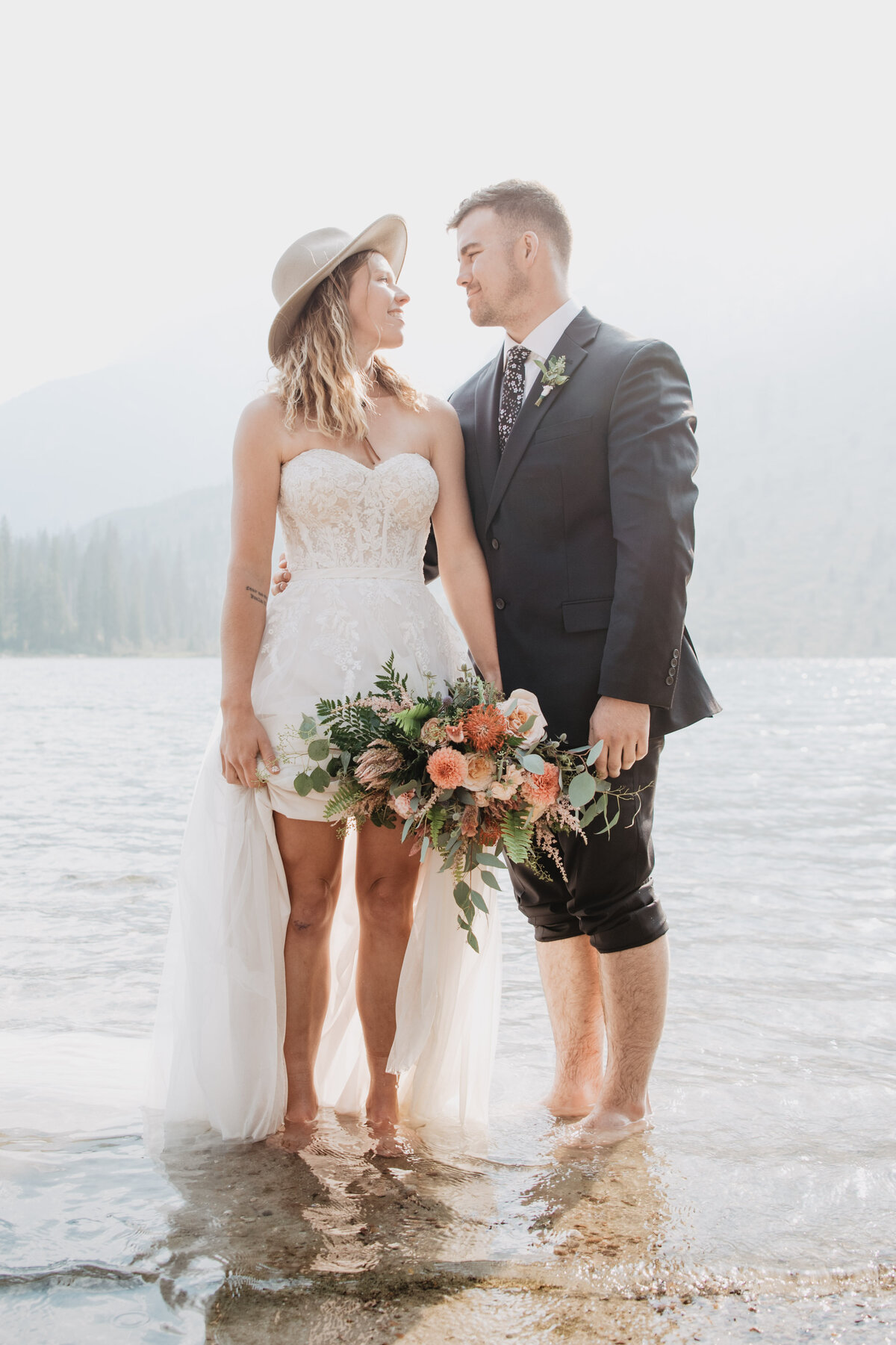 Jackson Hole Photographers capture adventure elopement portraits with bride and groom in water